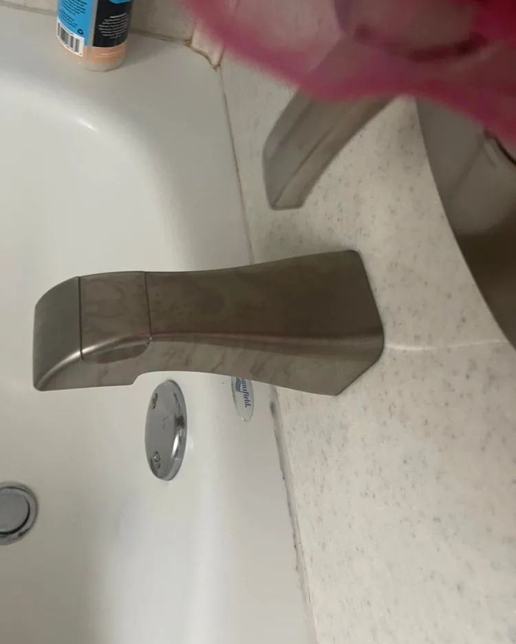 A polished chrome tub faucet after a MagiClean deep clean